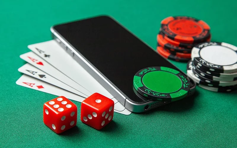Modern laptop showing a sleek, clean login screen surrounded by floating golden casino tokens – representing fast, reliable CROWNBD access in Bangladesh